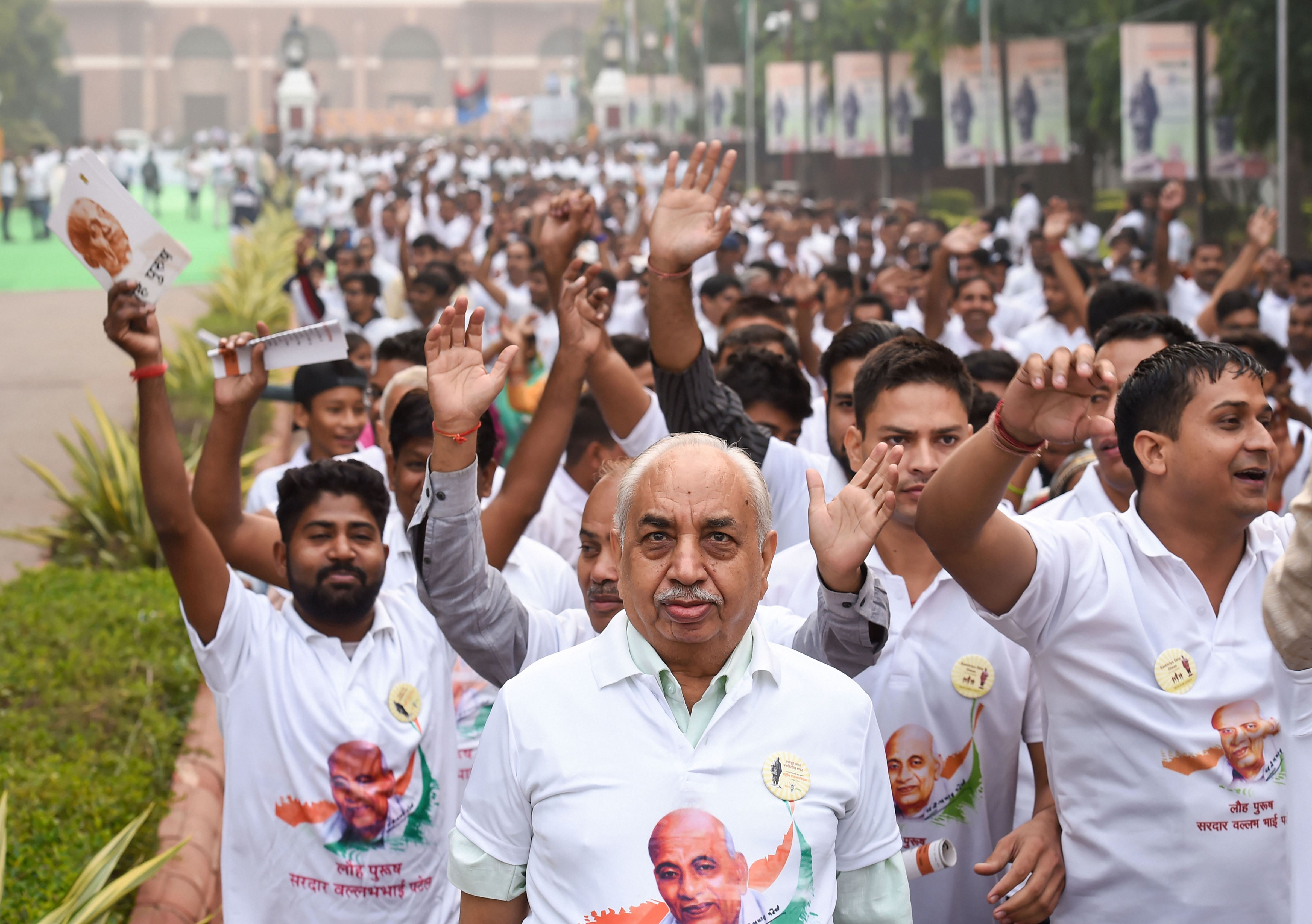 Participants run after the flag-off ceremony of 'Run For Unity' by Union Home Minister Amit Shah(unseen) from Delhi's National Stadium on the occasion of 144th birth anniversary of Sardar Vallabhbhai Patel - PTI