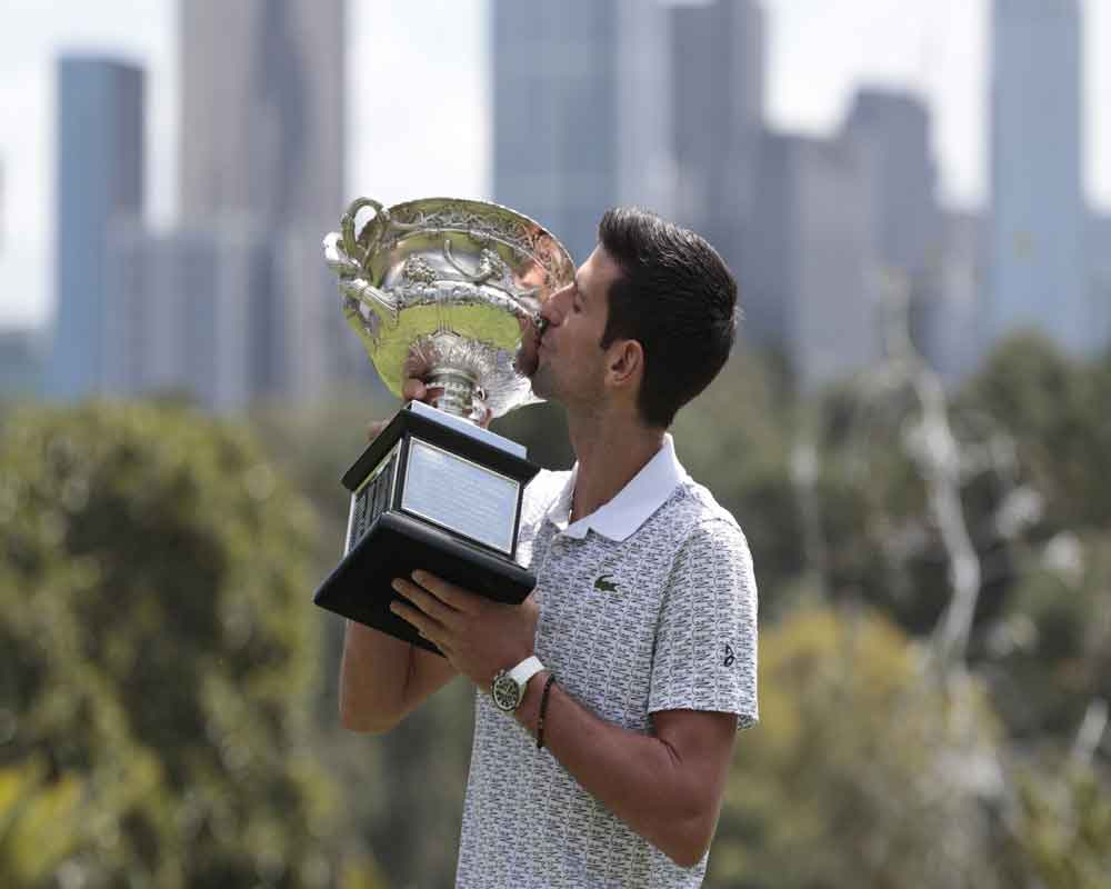 Serbia's Novak Djokovic poses with his trophy, the Norman Brookes Challenge Cup, during a photo shoot at Melbourne's Royal Botanic Gardens following his win over Austria's Dominic Thiem in the men's singles final of the Australian Open tennis championship in Melbourne, Australia - PTI