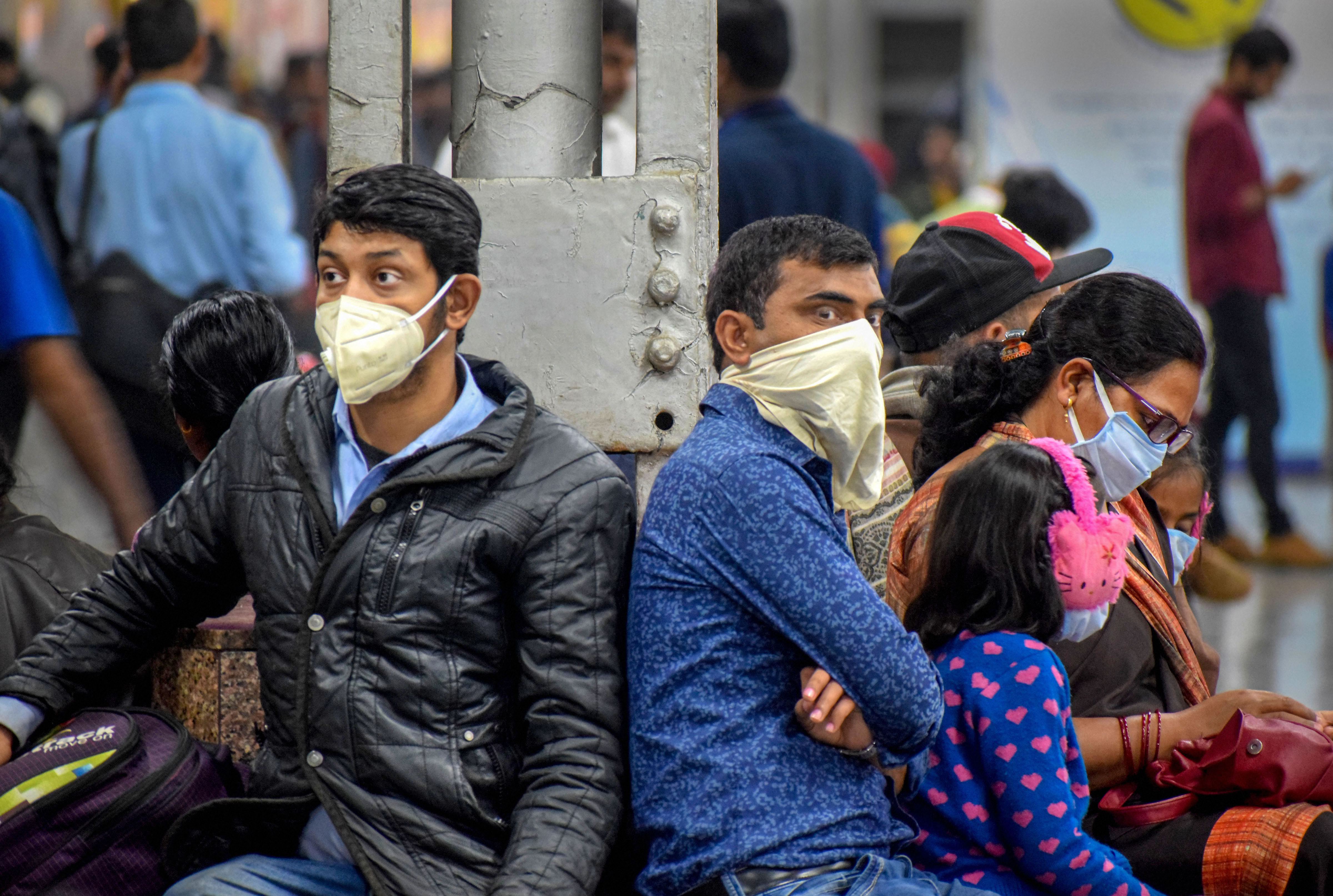 Passengers wear masks in the wake of coronavirus pandemic, at Prayagraj Railway Station- PTI