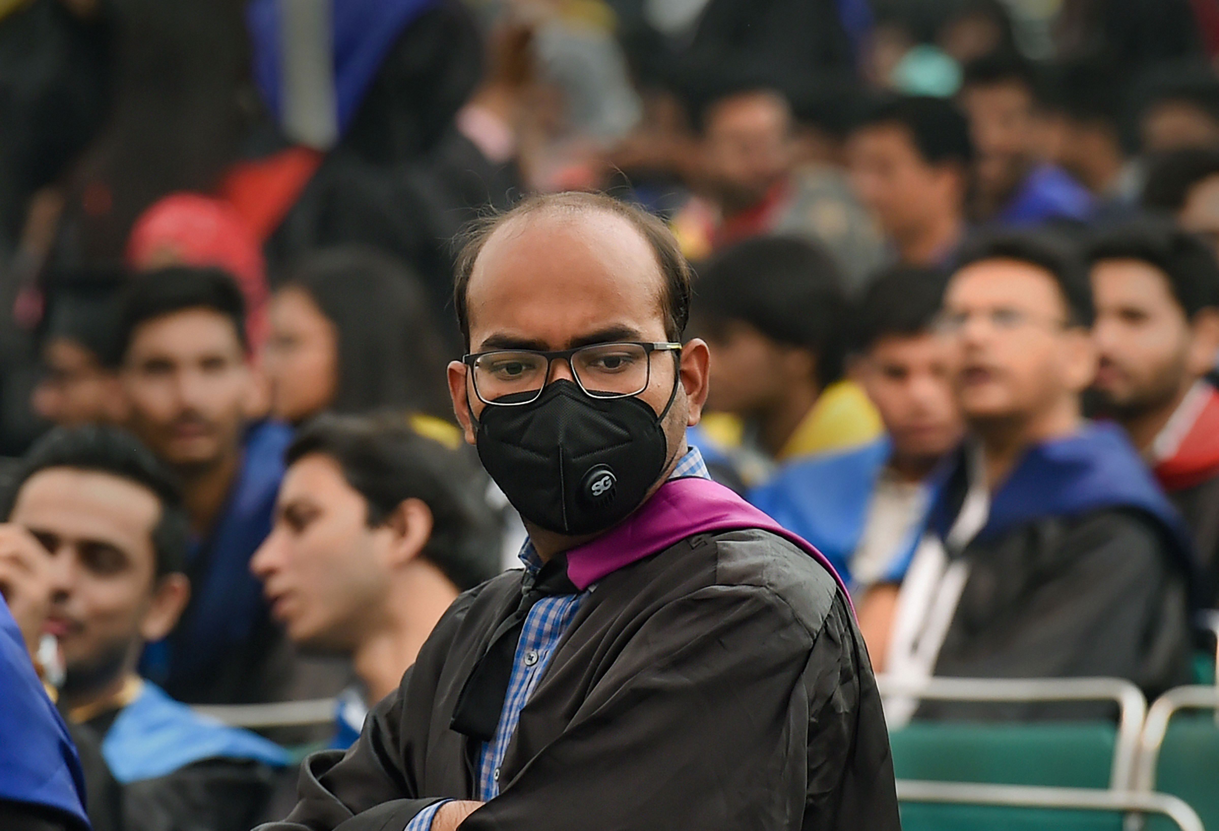 A student is seen wearing an anti-pollution mask during Jamia Millia Islamia's (JMI) Annual Convocation 2019 - PTI