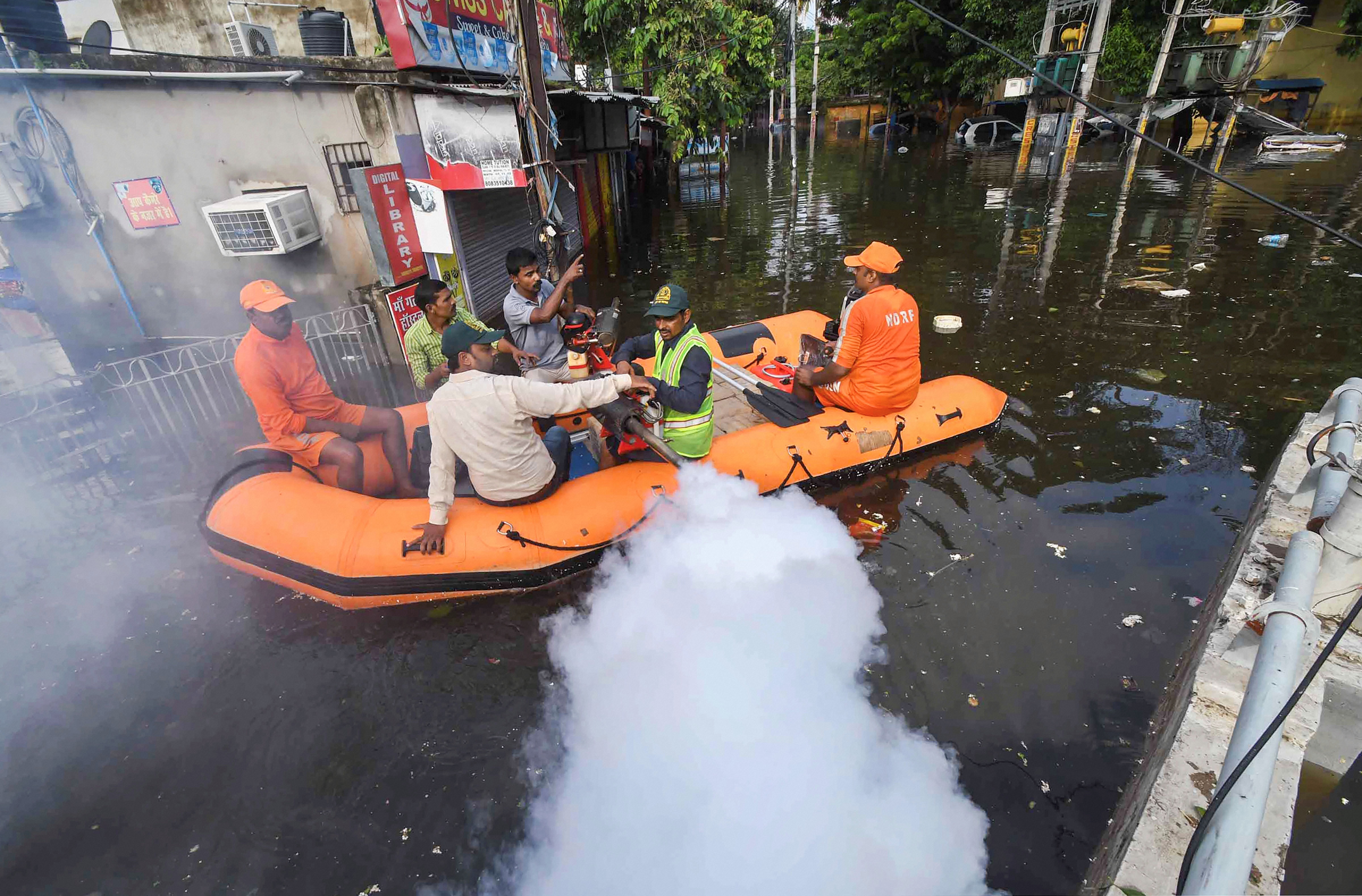 Patna Municipal Corporation (PMC) workers fumigate a flood-affected area as a precautionary measure against waterborne diseases following heavy monsoon rainfall - PTI
