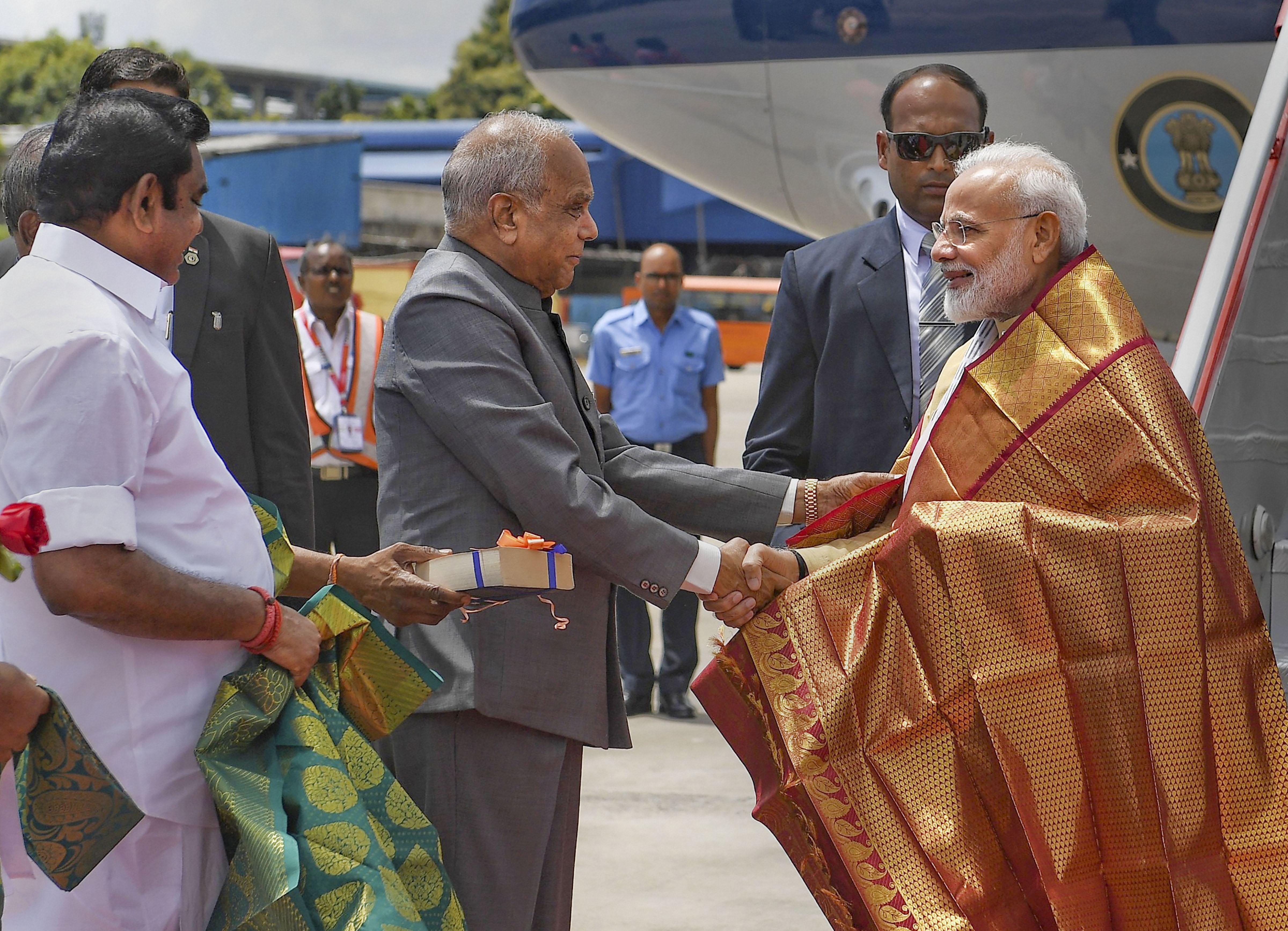 Prime Minister Narendra Modi being welcomed by Tamil Nadu Governor Banwarilal Purohit on his arrival, in Chennai, Friday, Oct. 11, 2019. Modi has arrived in Chennai ahead of his informal summit with Chinese President Xi Jinping at Mamallapuram - PTI