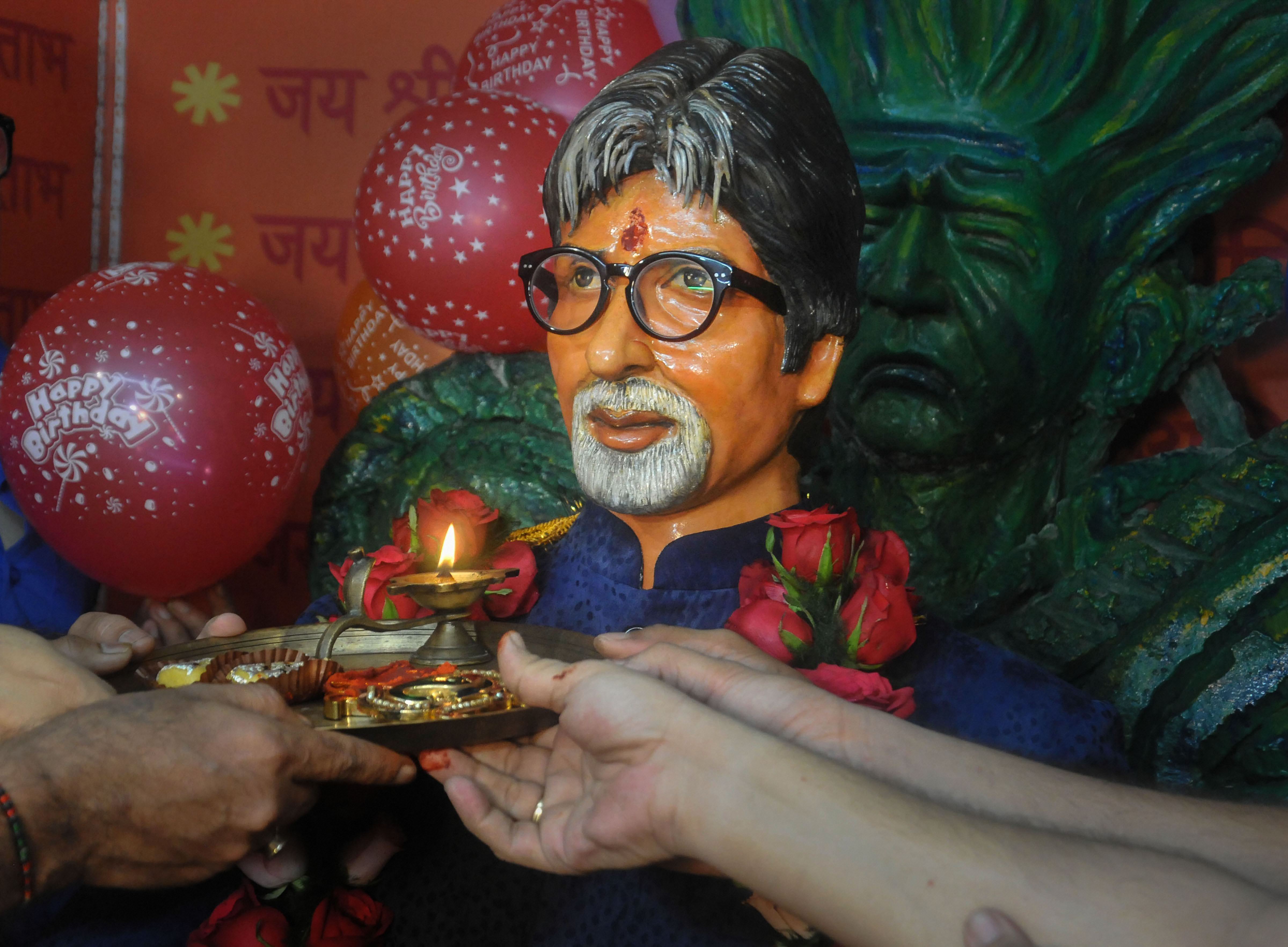 Fans of Bollywood actor Amitabh Bachchan offer 'aarti' in front of his bust to celebrate his 77th birthday, in Kolkata - PTI