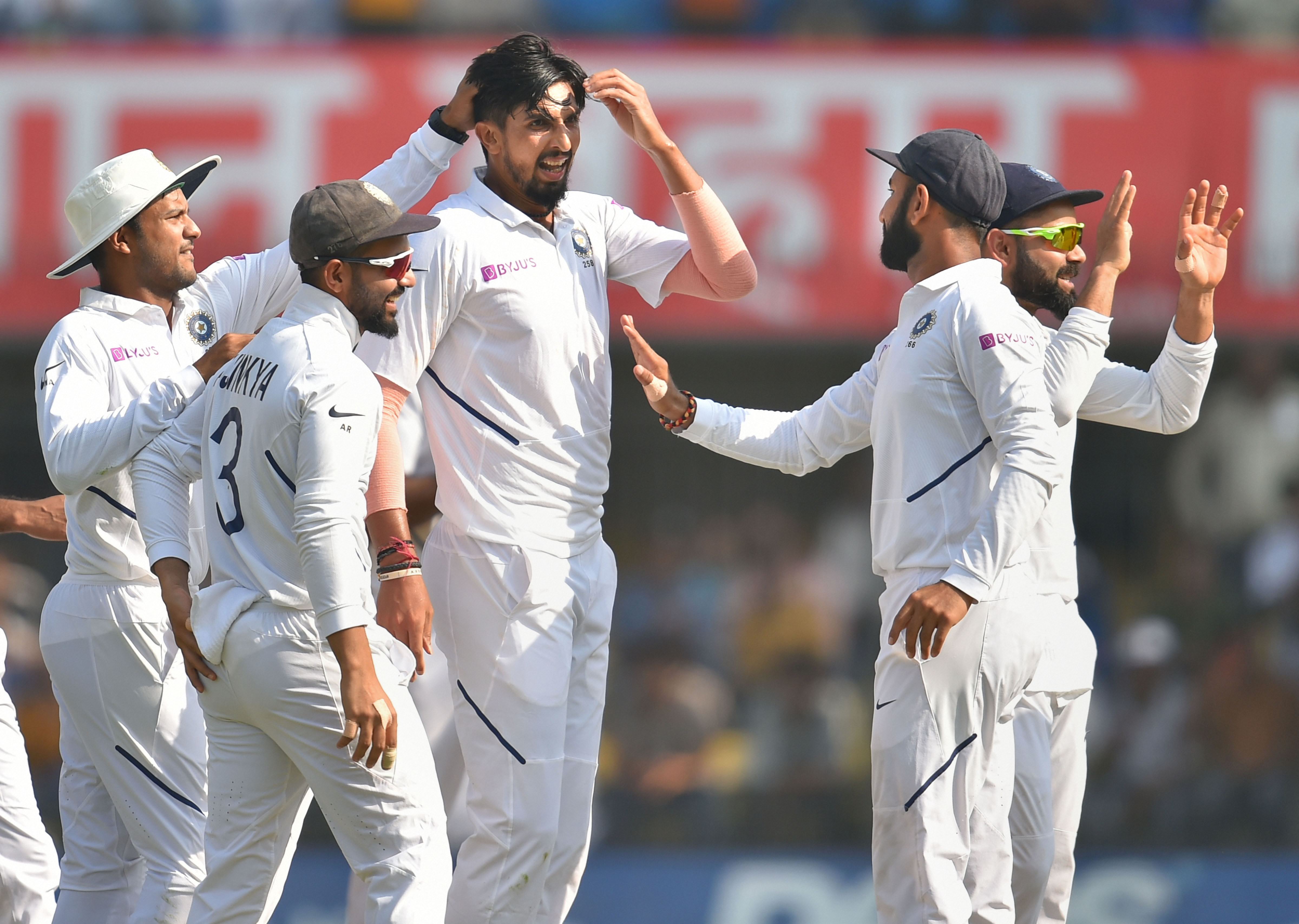 Indian bowler Ishant Sharma celebrates with captain Virat Kohli and other teammates the dismissal of Bangladesh batsman Shadman Islam on the first day of the first Test cricket match between India and Bangladesh - PTI