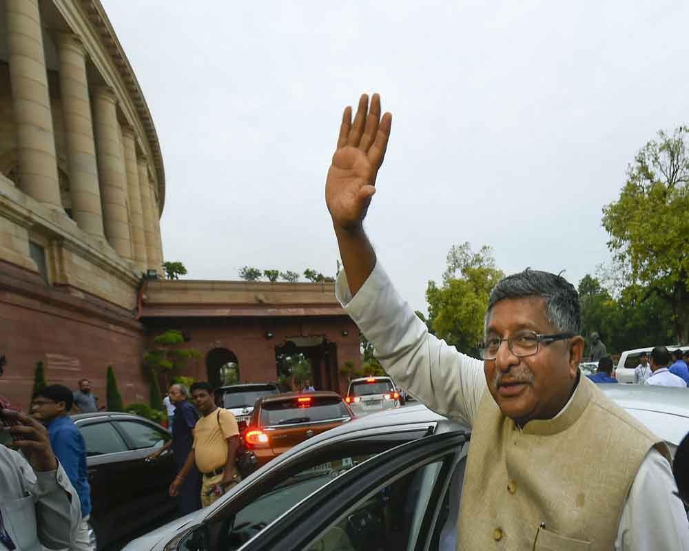 Union Law Minister Ravi Shankar Prasad waves at the media as he comes out after the passage of triple talaq bill in the Rajya Sabha, at Parliament - PTI