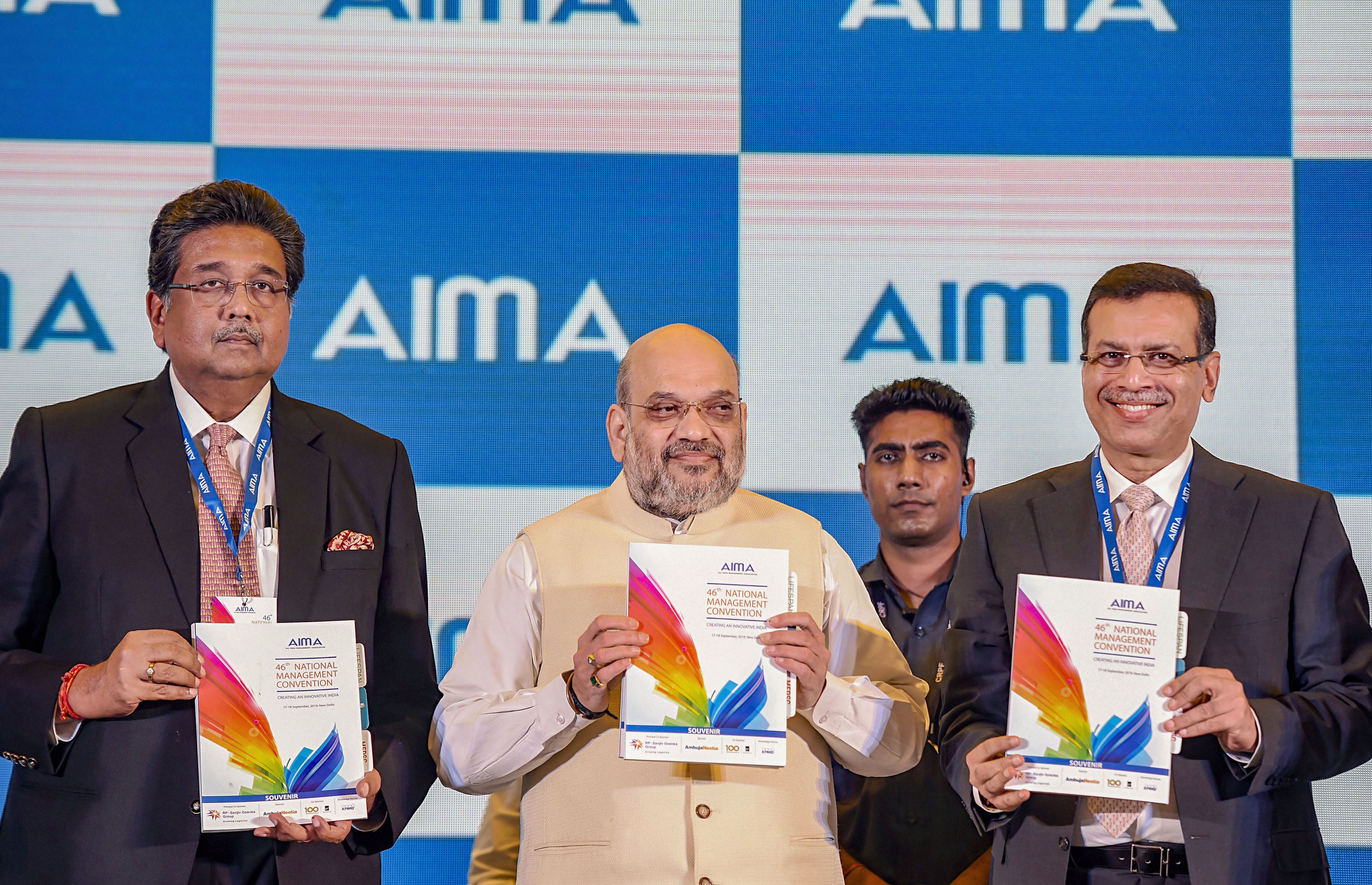 Home Minister Amit Shah, RP-Sanjiv Goenka Group Chairman Sanjiv Goenka and Ambuja Neotia Group Chairman Harshavardhan Neotia release the convention souvenir during the 46th National Management Convention of the AIMA - PTI