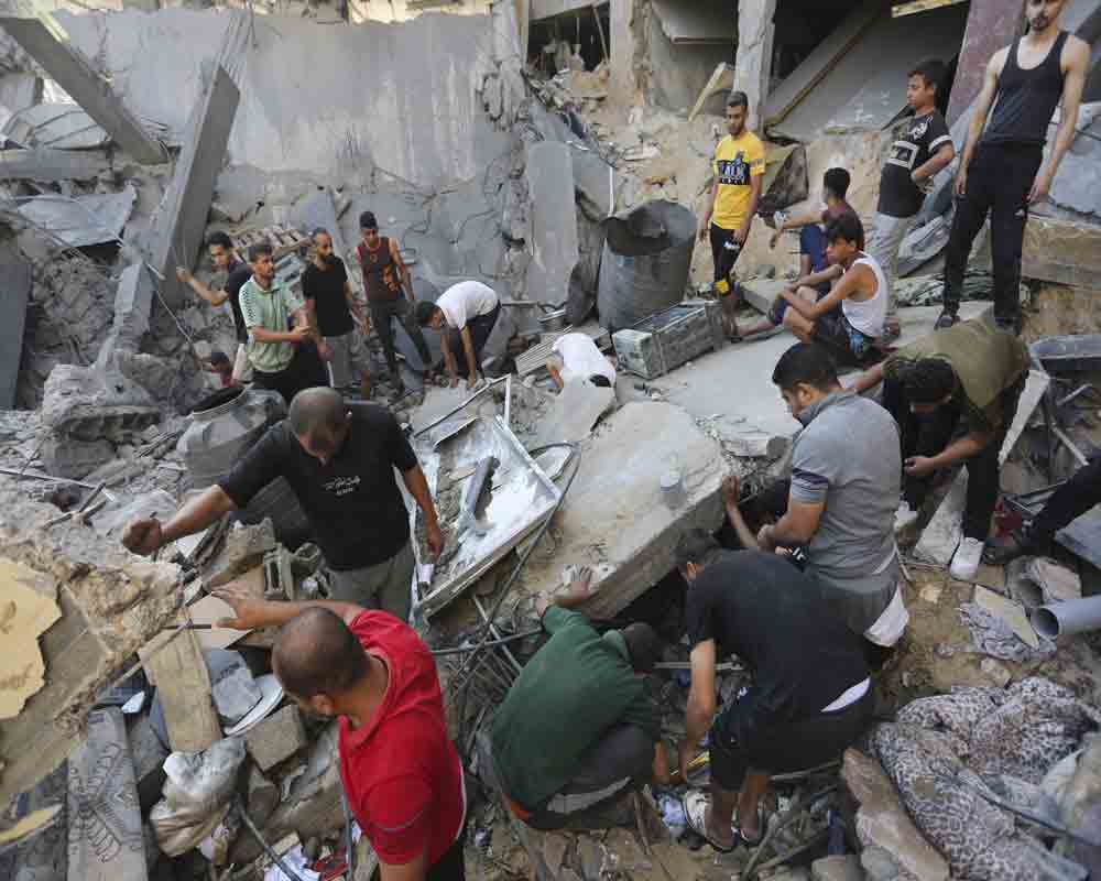 Palestinians look for survivors after an Israeli strike in Rafah, Gaza Strip - PTI