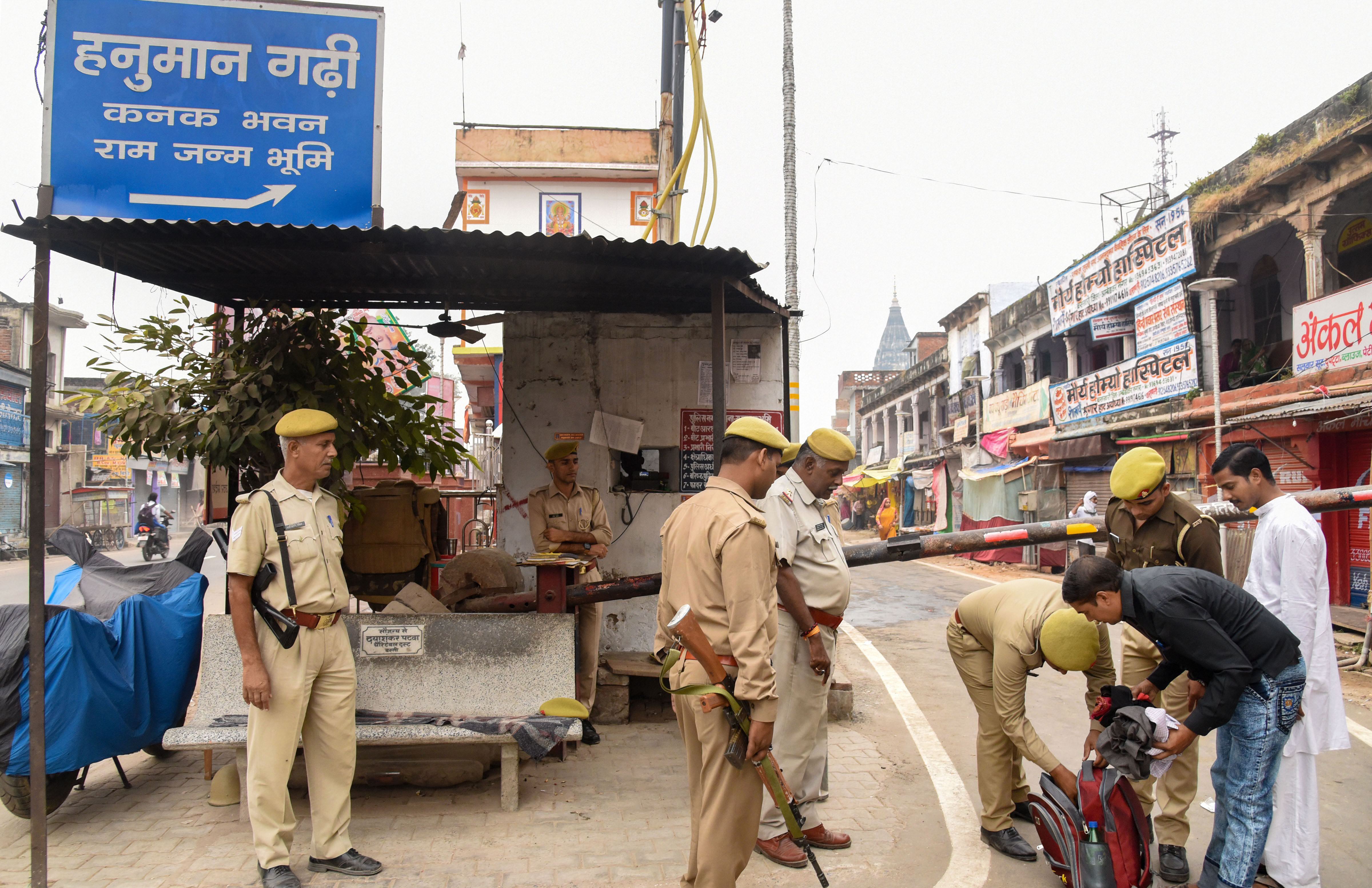 Police personnel conduct checks at a barricade point ahead of 'Deepotsav' festival, in Ayodhya - PTI