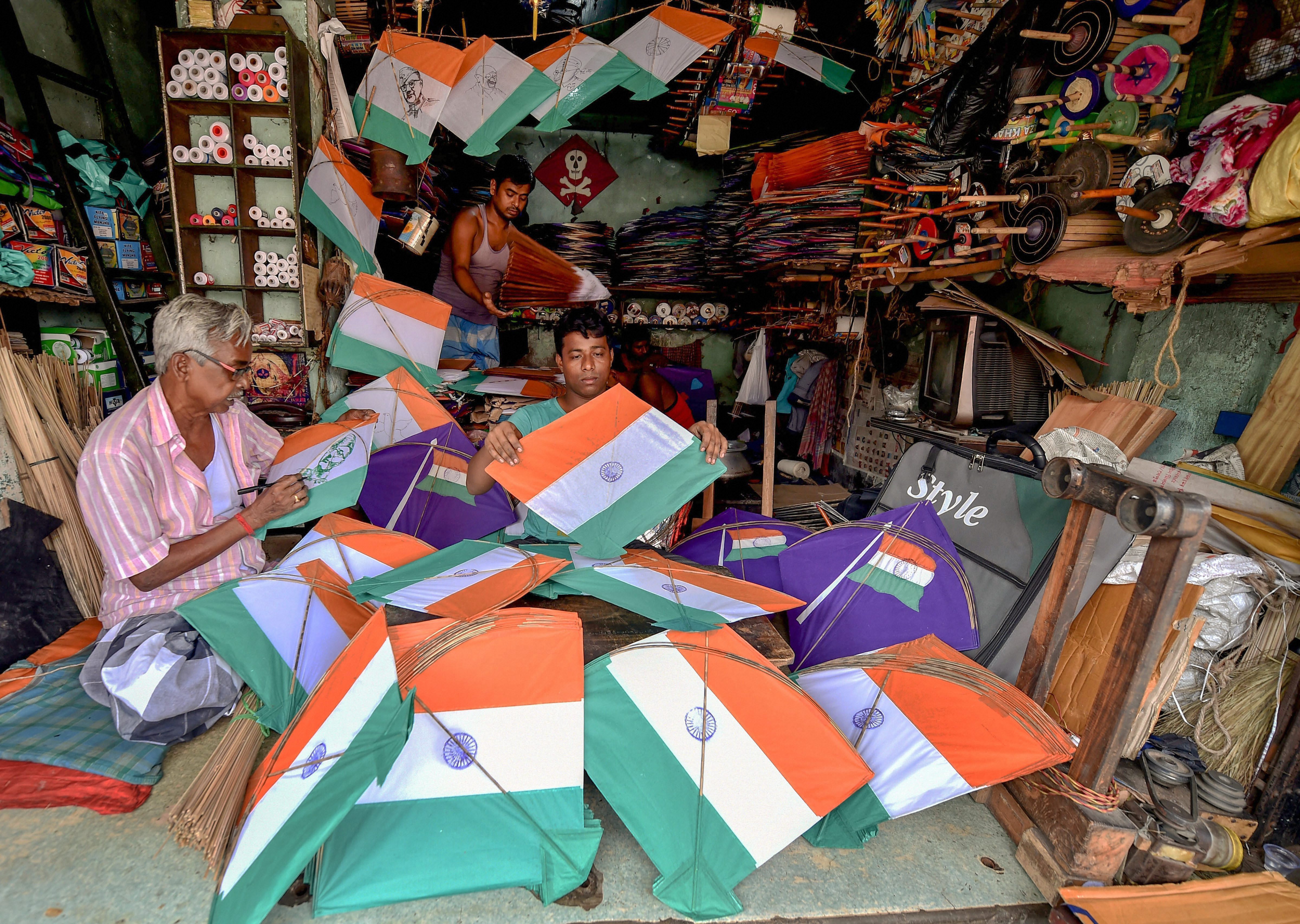 Kite makers busy in preparing tri-coloured kites at a workshop, ahead of the Independence Day celebrations, in Kolkata - PTI