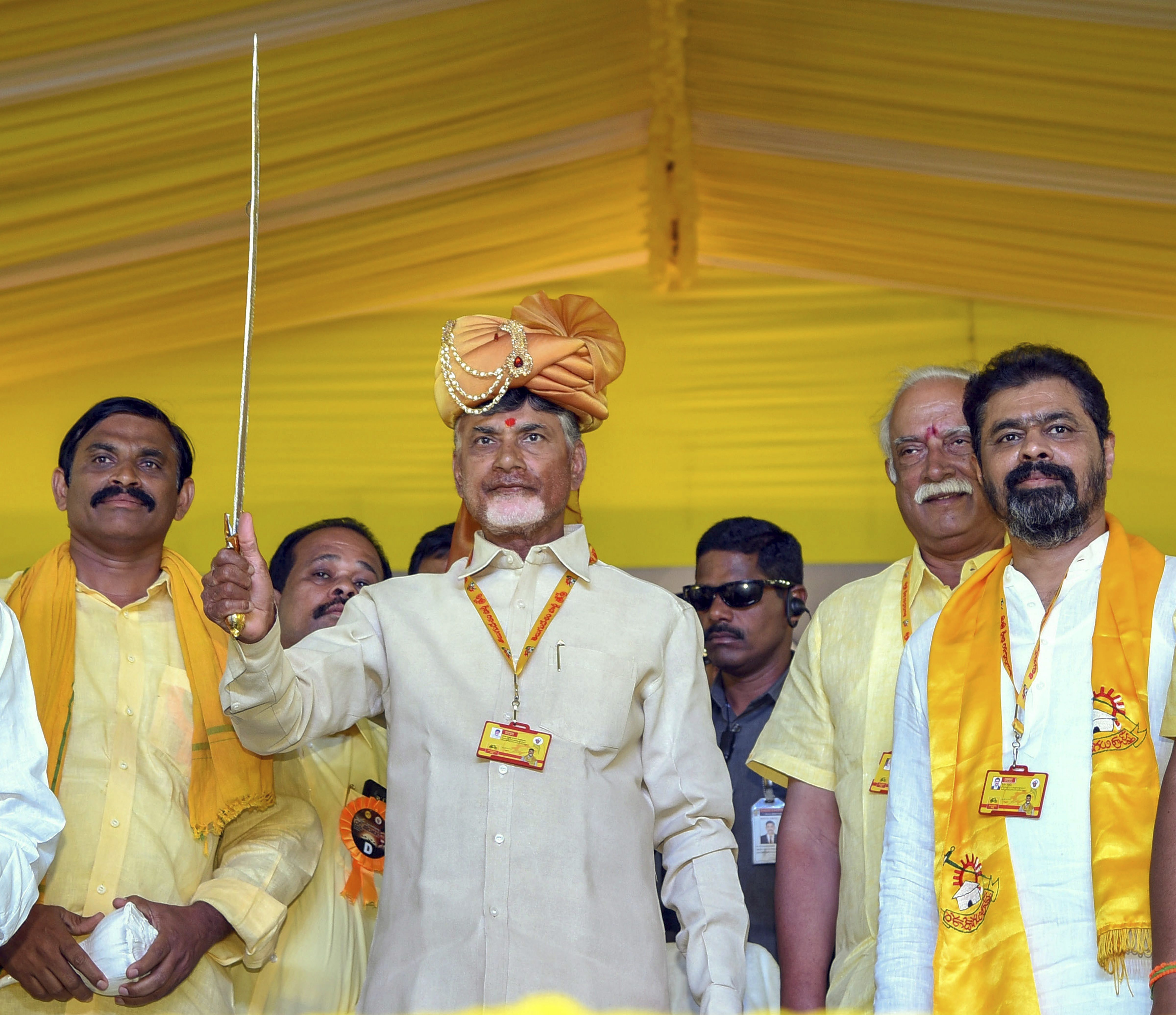 Andhra Pradesh Chief Minister Chandrababu Naidu holds a sword during 'Dharma Porata Deeksha' being held at Produturu, in Kadapa - PTI
